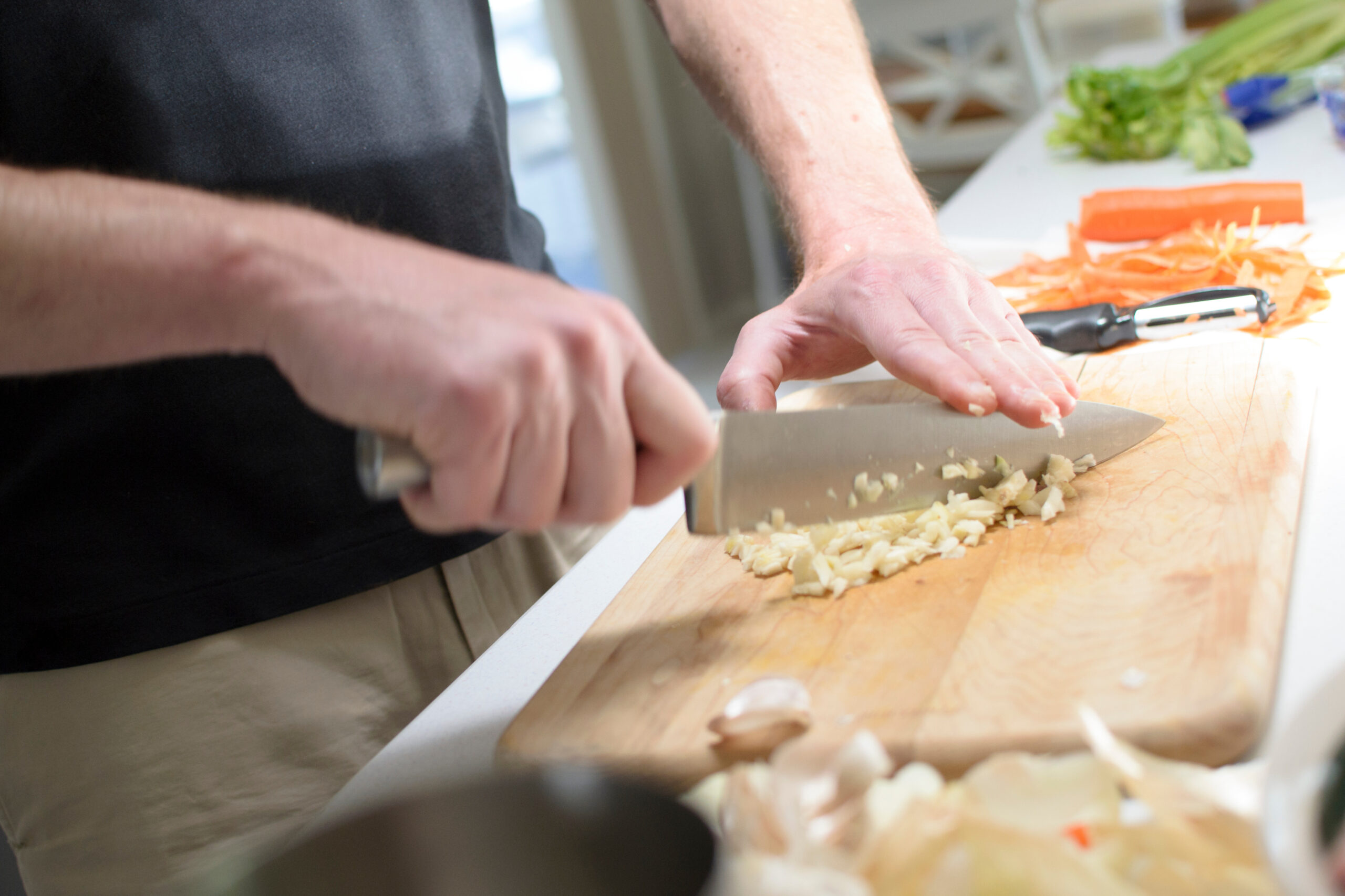 chopping garlic on cutting board